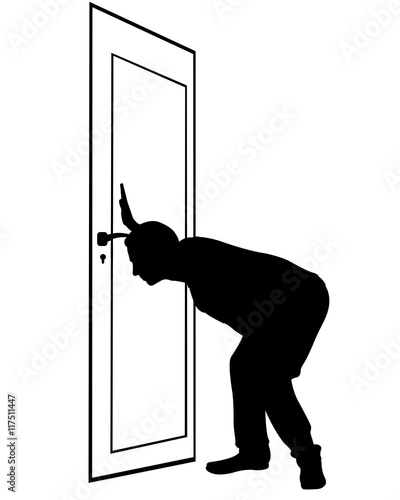 man looking through keyhole