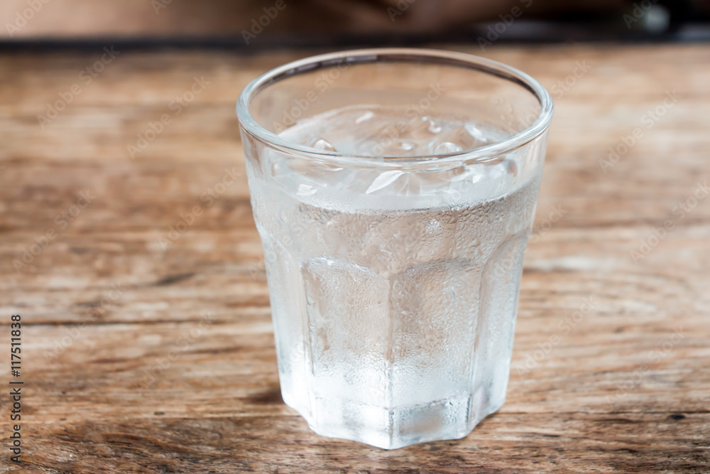 Iced water on wooden table Iced water on wooden table