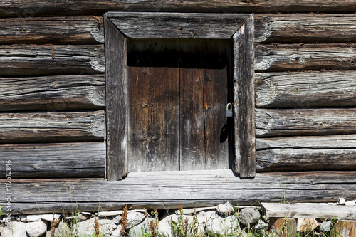 Beautiful old door on the wooden wall of the old house. Excellent background. photo