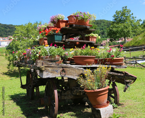 wooden wagon decorated with many pots of flowers