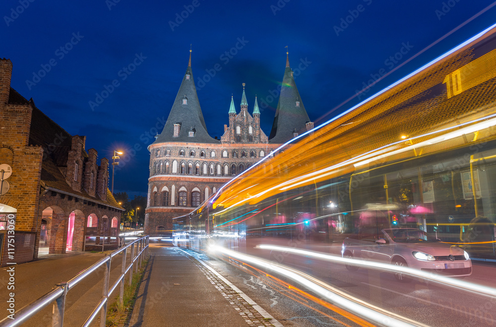 Lubeck, Germany. Medieval Holstentor gate at night with car and