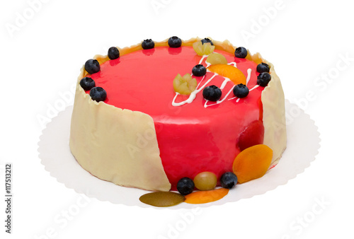 birthday cake with red icing and berrys isolated over white