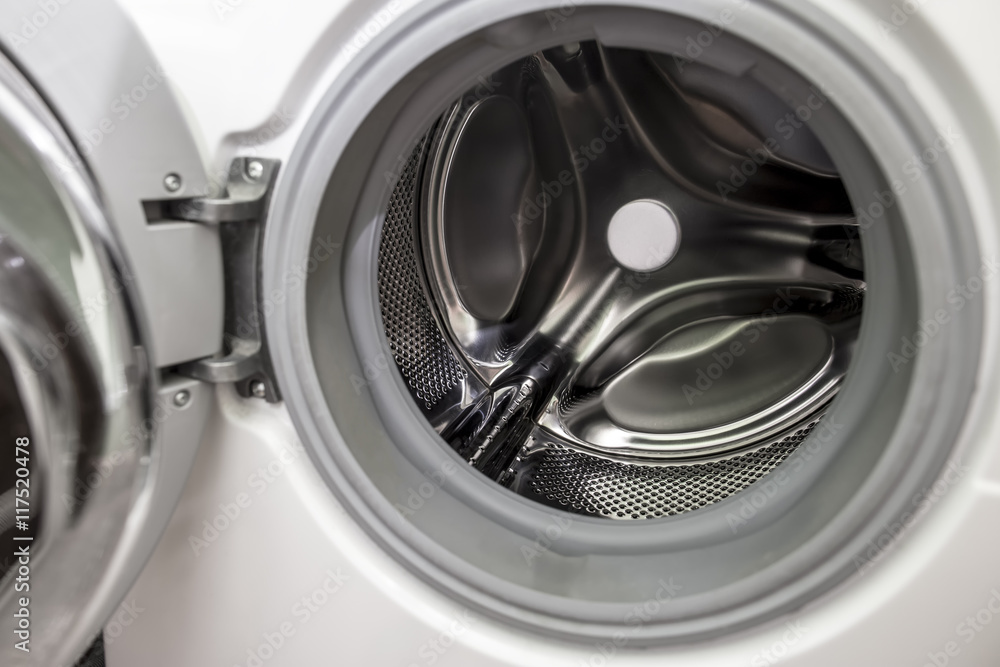 Opened door of empty washing machine with a drum and a horizontal load of laundry Opened door of empty washing machine with a drum and a horizontal load of laundry