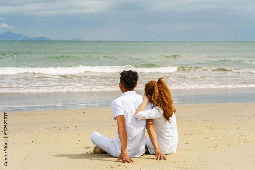 Young couple sitting and looking at the sea in Danang