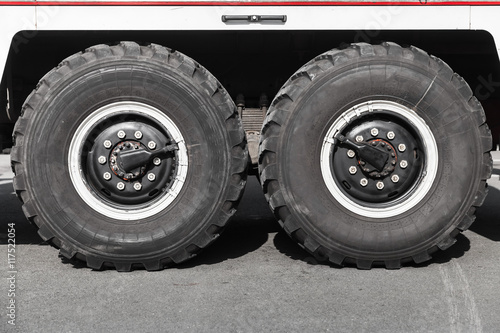 Twin truck wheels on asphalt road