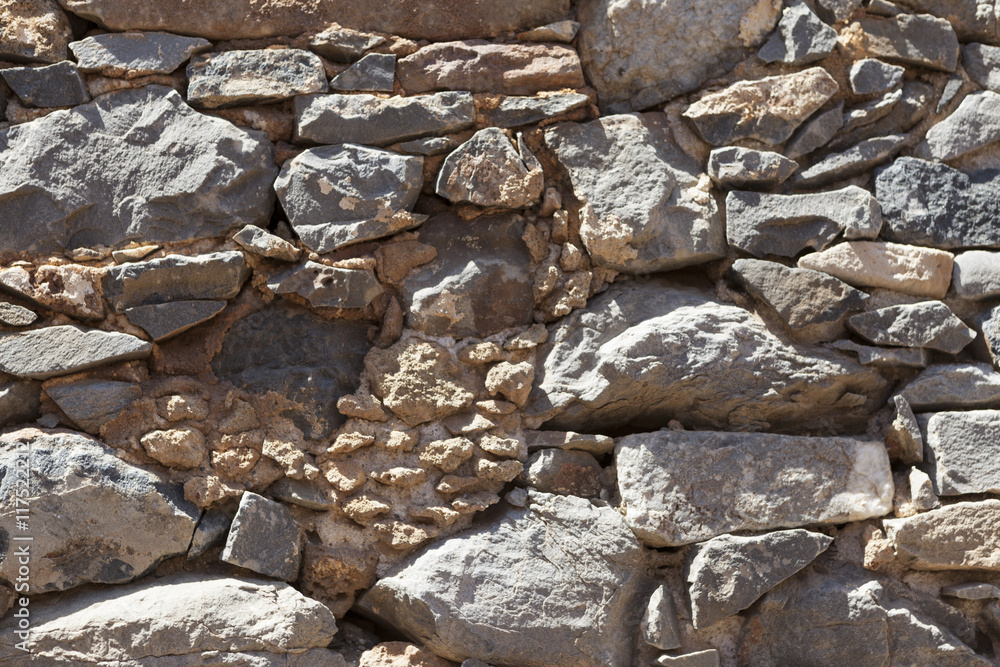 Fototapeta premium Wall from large stone textured basalt. Good background for wallpaper.