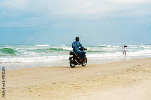 Man riding motorbike at China Beach in Danang in Vietnam
