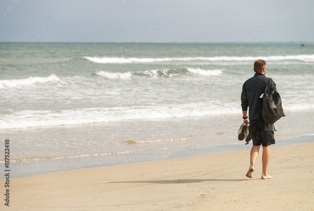 Young man passing by at the China Beach of Danang