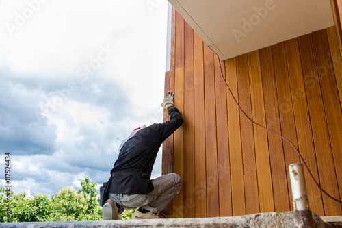 Bilde på lerret Men build siding Fiber Cement Board on wall exterior
