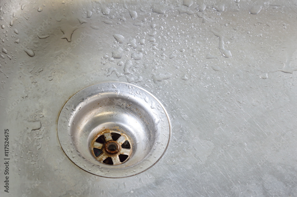 drop of water on silver stainless sink hole drop of water on silver stainless sink hole