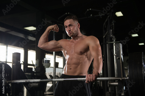 Healthy Young Man Flexing Muscles