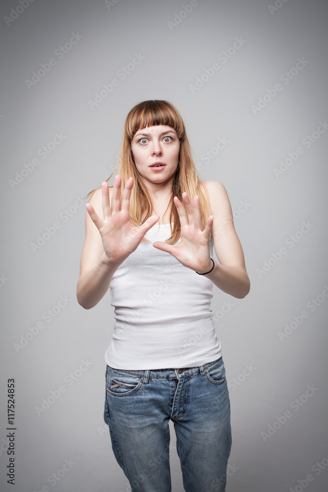 young girl recoiled in fright, protecting himself with his hands young girl recoiled in fright, protecting himself with his hands