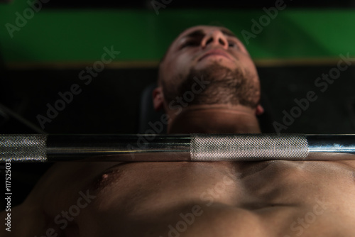 Muscular Man Doing Bench Press Exercise For Chest
