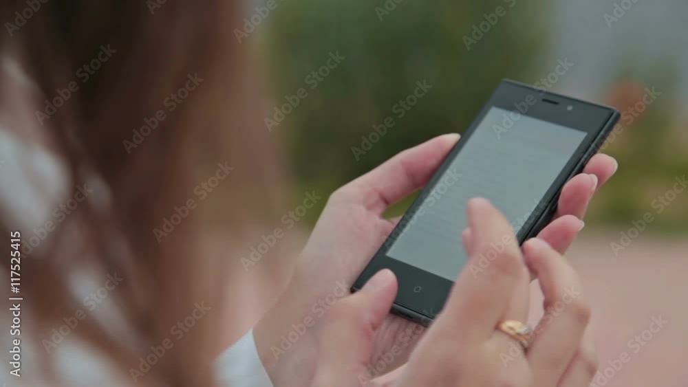 Close up of Woman Hands Using Smartphone with Beautiful Nature on the Background Close up of Woman Hands Using Smartphone with Beautiful Nature on the Background