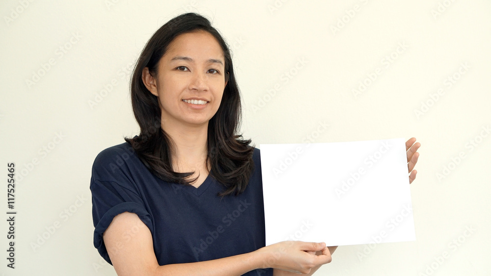 South East Asian girl casually holding while sign for copy space South East Asian girl casually holding while sign for copy space