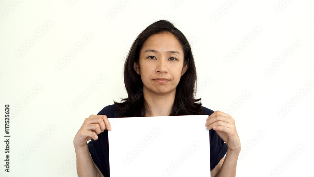 South East Asian girl casually holding while sign for copy space South East Asian girl casually holding while sign for copy space