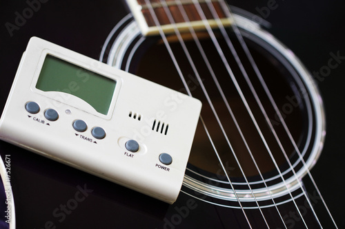 Quadro em tela Guitar and tuner for toning musical instruments