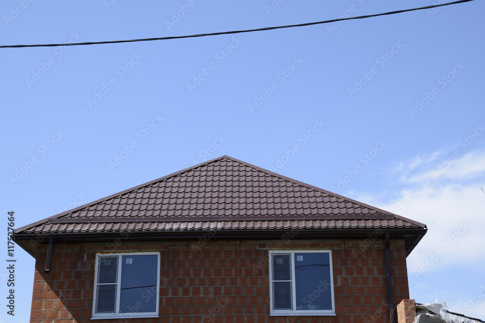 House with a roof made of metal sheets House with a roof made of metal sheets