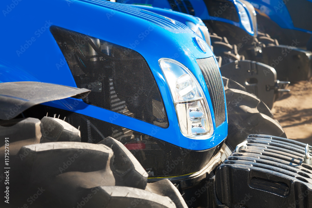 Fototapeta premium Close up of tractors on a row