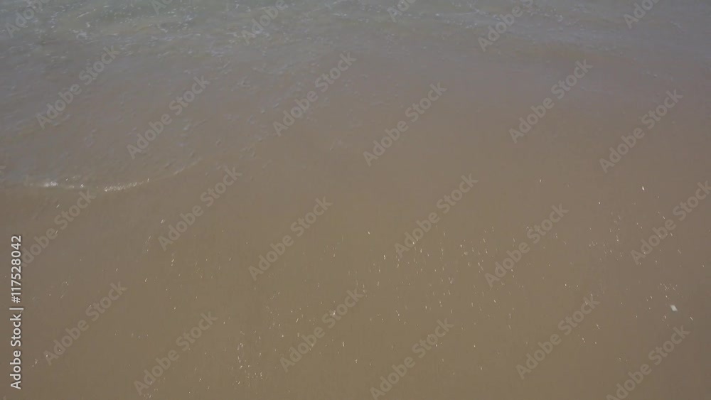 Sea Waves over Sand Beach. Beach sand textured background with waves coming an going back to the sea. Revers video. Sea Waves over Sand Beach. Beach sand textured background with waves coming an going back to the sea. Revers video.