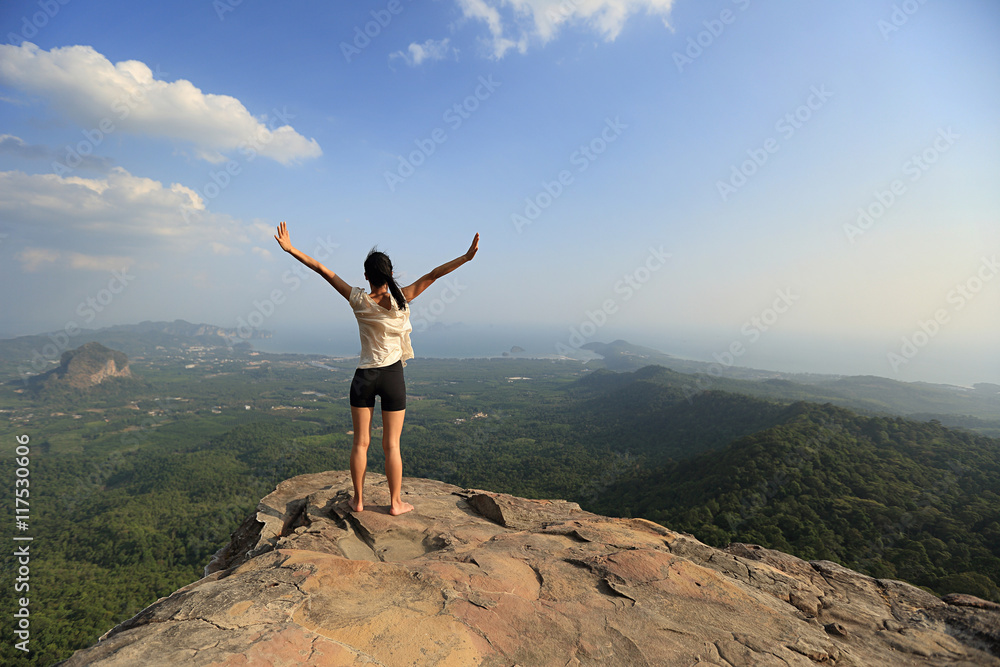 young freedom woman open arms on mountain peak young freedom woman open arms on mountain peak