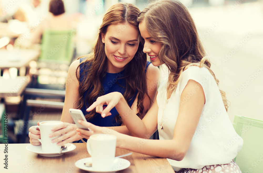 young women with smartphone and coffee at cafe young women with smartphone and coffee at cafe