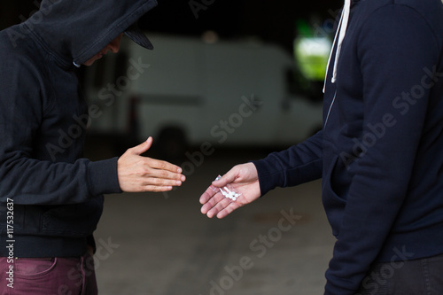 close up of addict buying dose from drug dealer