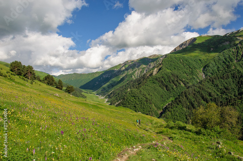 Girl with a big backpack is traveling in the Caucasus mountains  Georgia.