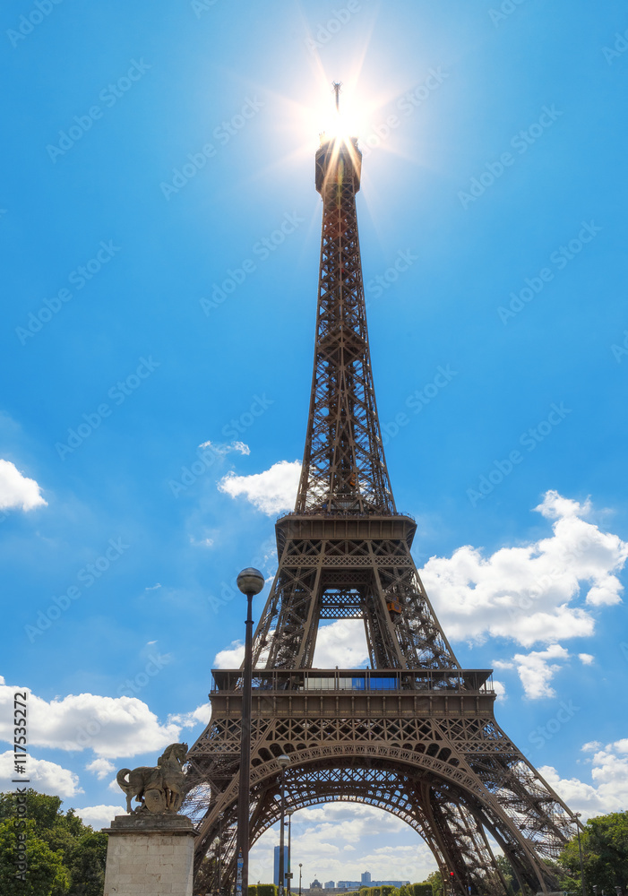 Eiffel Tower. Sceme with spot of sun at the top. France, Paris.