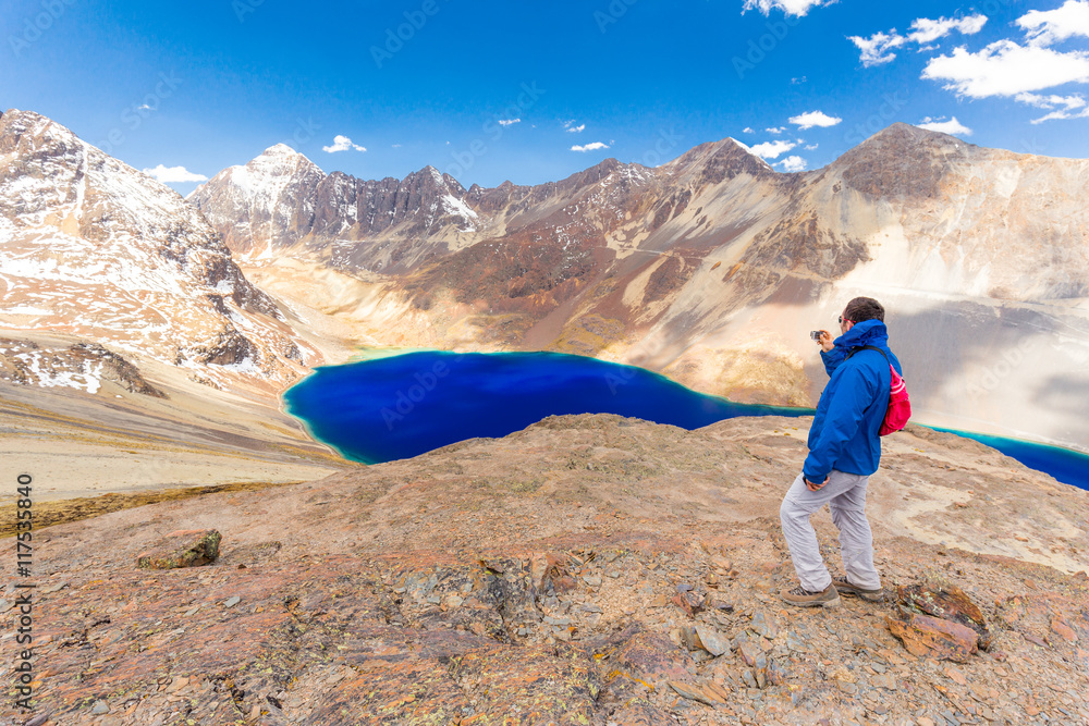 Photographing man tourist Bolivia mountains  lake  road.