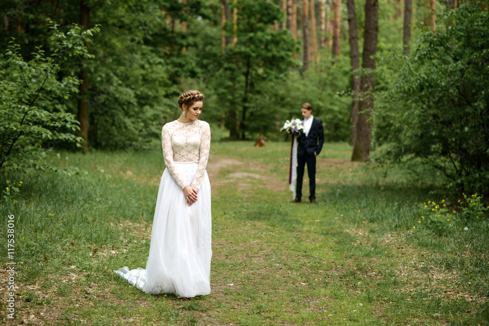 bride and groom in the woods. young couple in the woods.