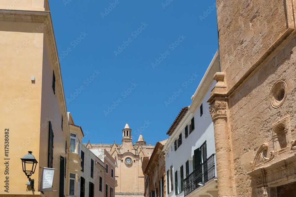 Stone houses with church and clock under the blue sky