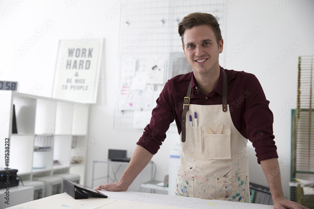 Portrait Of Young Man Working In Screen Printing Business Portrait Of Young Man Working In Screen Printing Business