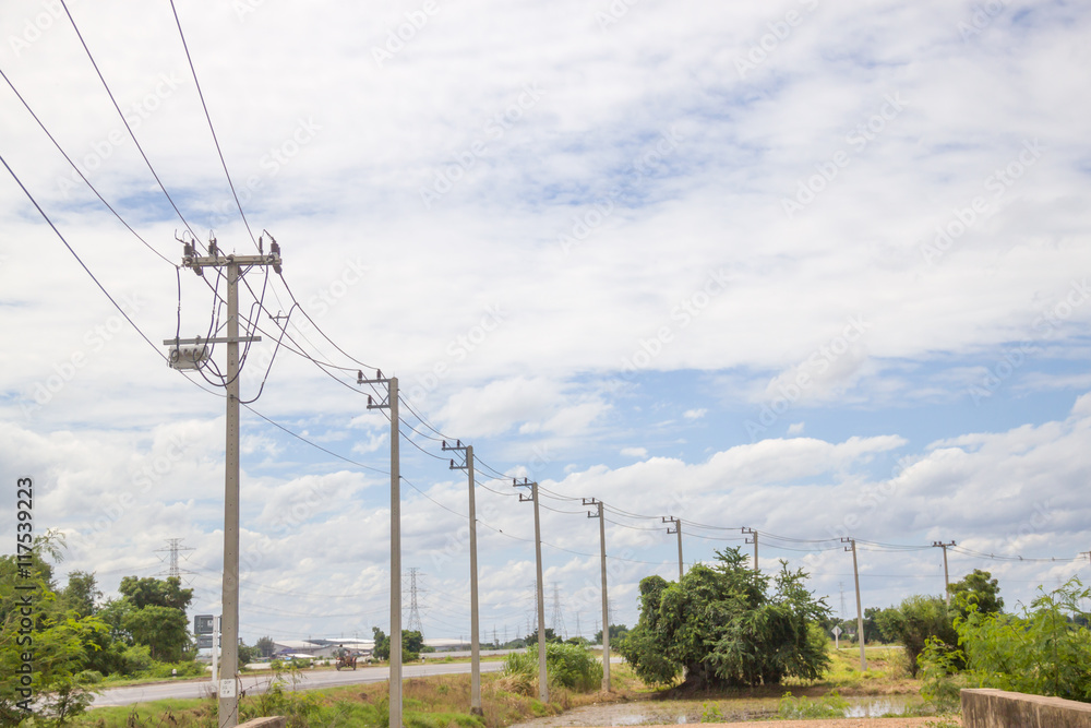 Electricity pylon silhouetted against blue sky wih cloud background. High voltage tower Electricity pylon silhouetted against blue sky wih cloud background. High voltage tower