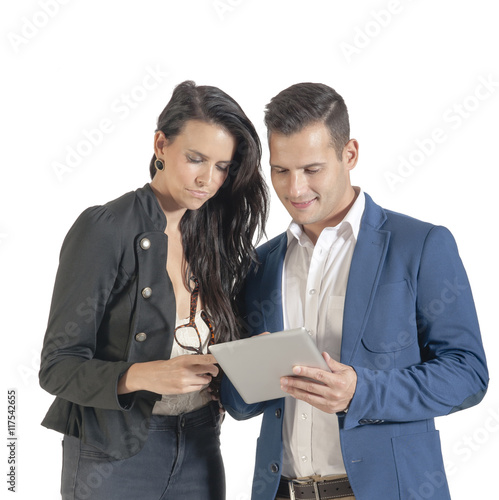 Two young business people interacting with technology.