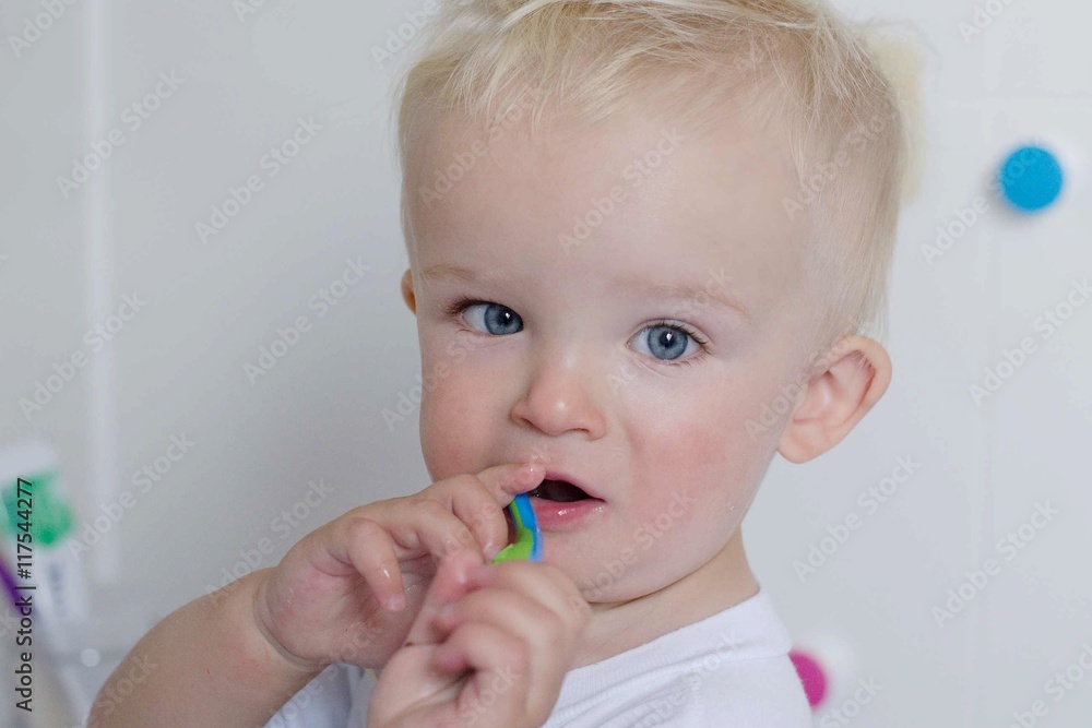 One year old boy is brushing teeth by himself at bathroom. One year old boy is brushing teeth by himself at bathroom.