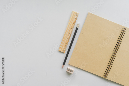 black pencil and brown notebook with ruler on table. school concept © fufupix