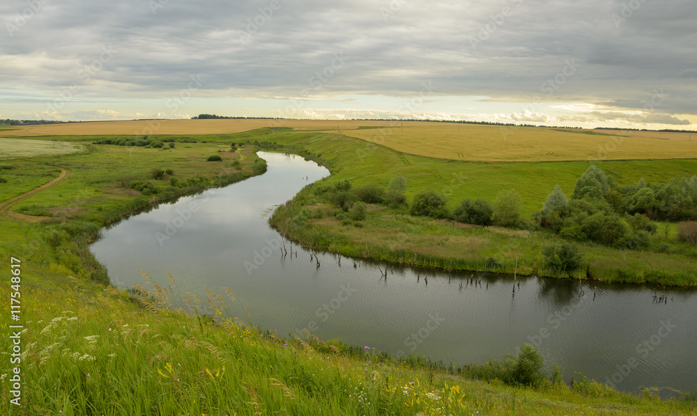 Cloudy summer landscape with river