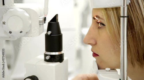 Ophthalmologist checks woman's eyes