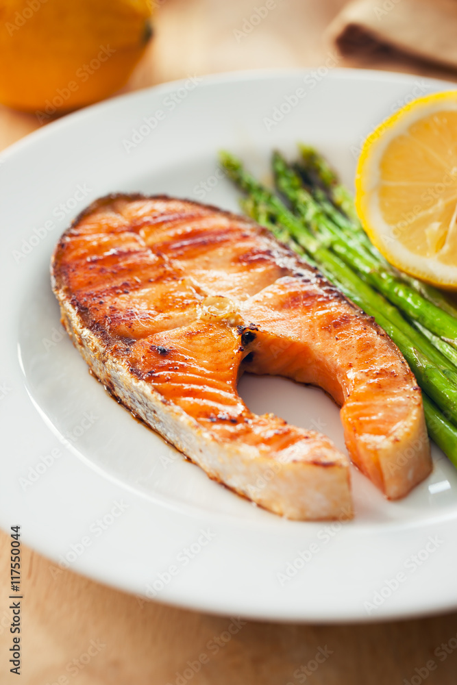 salmon steak with asparagus in plate
