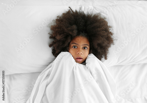 Cute African girl in bed