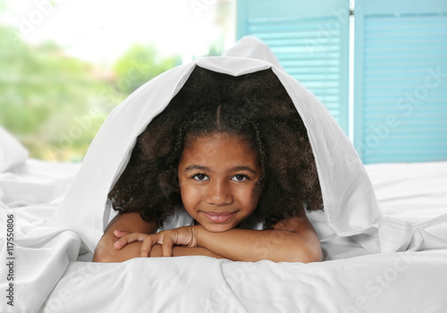 Cute African girl in bed