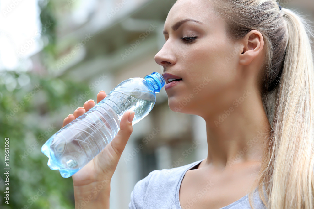 Beautiful girl drinking water on street Beautiful girl drinking water on street