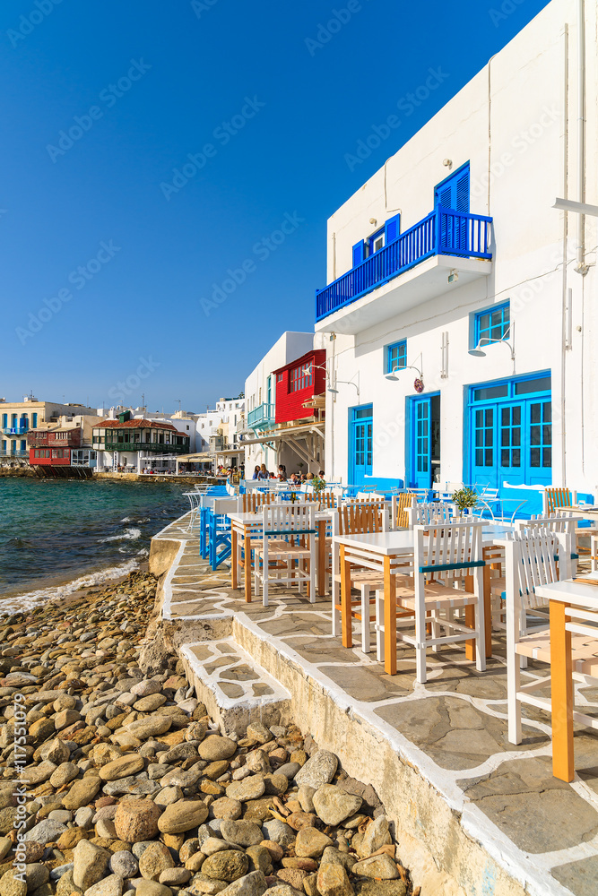 Taverna tables on coastal promenade along beach in Little Venice part of Mykonos town, Mykonos island, Greece