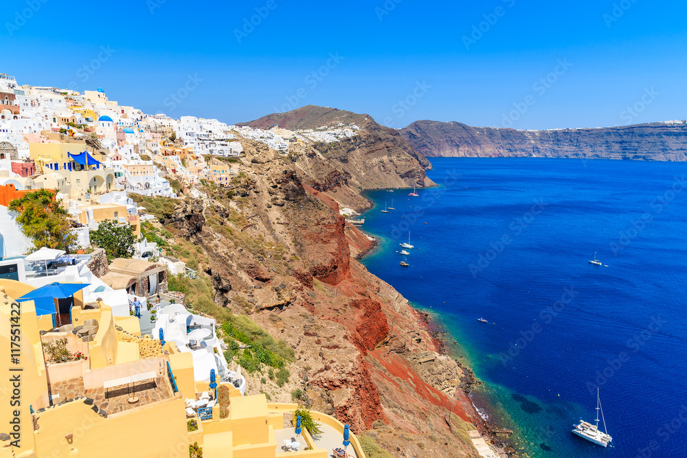 View of Fira village built on top of volcano cliff and blue sea Santorini island, Greece