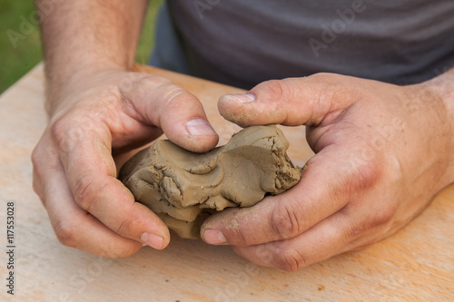 two hands shaped piece of clay