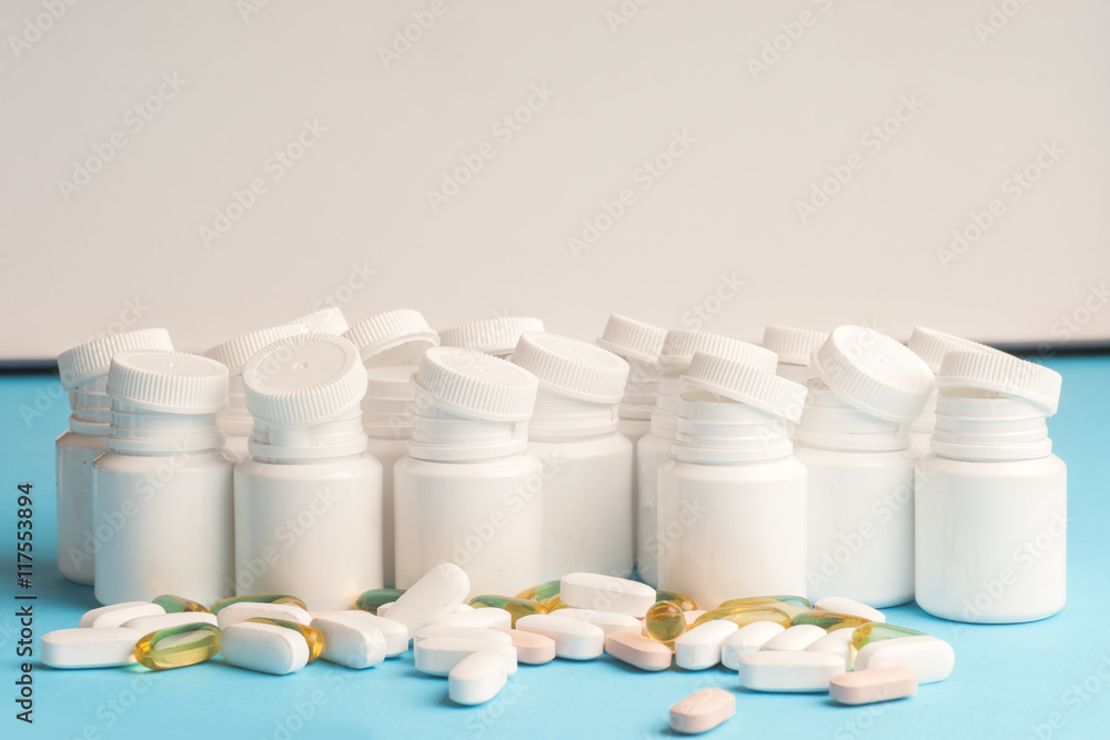 Many pills and tablets isolated on light blue background Many pills and tablets isolated on light blue background
