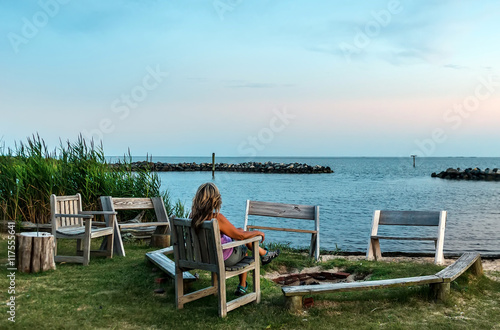 Female watching a sunset on a Chesapeake Bay beach
