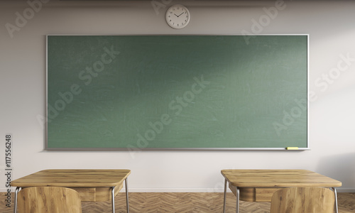 Green chalkboard and two desks