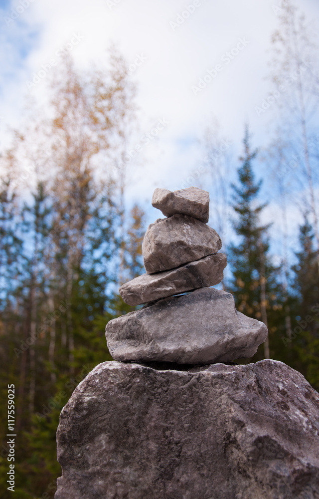 Pyramid of granite stones in the autumn park Pyramid of granite stones in the autumn park